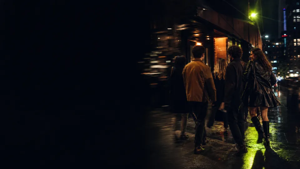 Friends moving toward a Toronto venue on a wet night